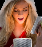 Pretty blonde in santa outfit opening gift