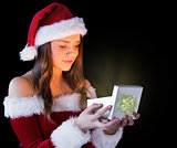 Pretty brunette in santa outfit opening gift