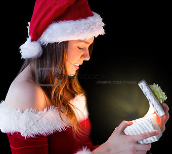 Pretty brunette in santa outfit opening gift