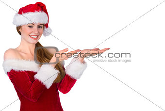 Pretty redhead in santa outfit presenting with hands