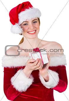 Pretty girl in santa costume holding gift box