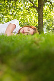 Pretty redhead lying on the grass