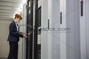 Technician working on servers using tablet pc
