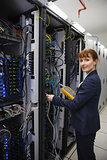 Happy technician using digital cable analyzer on server