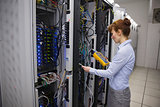 Technician using digital cable analyzer on server