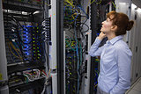 Technician talking on phone while analysing server