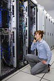 Technician talking on phone while analysing server