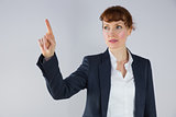Businesswoman in suit pointing finger