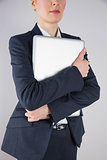 Businesswoman in suit holding laptop