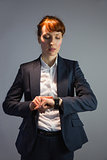Businesswoman in suit checking the time
