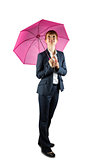 Smiling businesswoman holding pink umbrella