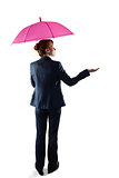 Smiling businesswoman holding pink umbrella