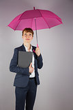Businesswoman in suit holding pink umbrella and notepad
