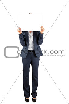 Businesswoman holding card over face