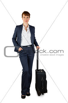 Smiling businesswoman holding her suitcase