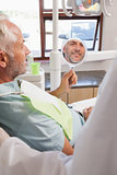 Patient admiring new smile in the mirror