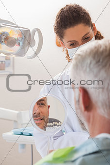 Patient admiring his new smile in the mirror