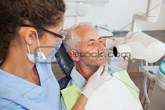 Dentist taking an xray of patients mouth
