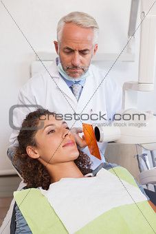 Dentist taking an xray of patients mouth