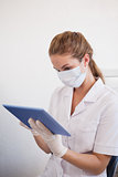 Dental assistant working on tablet pc