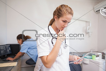 Dental assistant looking at x-ray