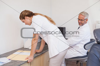 Dentist checking out his assistant