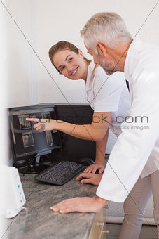 Dentist and assistant studying x-rays on computer