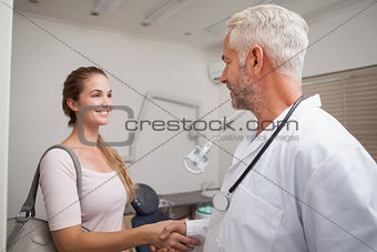 Dentist shaking hands with his patient