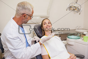 Dentist speaking with patient in the chair