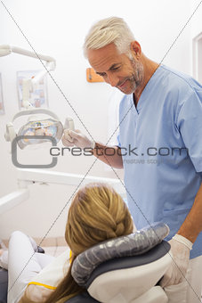 Dentist smiling at patient in the chair