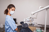 Dentist in surgical mask looking at camera