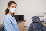 Dentist in surgical mask looking at camera