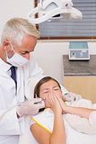 Pediatric dentist trying to see sneezing patients teeth