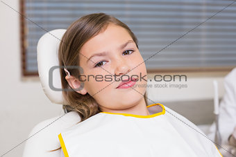 Little girl sitting in dentists chair