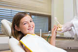 Pediatric dentist showing little girl teeth model