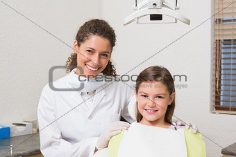Little girl smiling at camera with her pediatric dentist