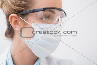 Dentist with surgical mask and protective glasses