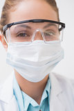 Dentist with surgical mask and protective glasses