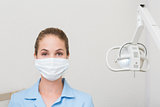 Dental assistant in mask looking at camera