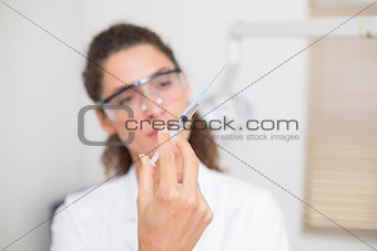 Dental assistant preparing an injection
