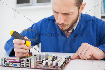 Computer engineer working on cpu with screwdriver