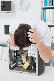 Computer engineer looking at broken device