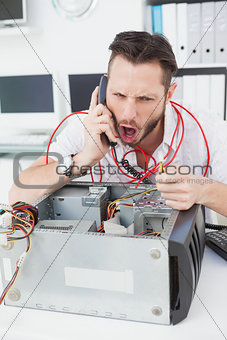 Angry computer engineer making a call
