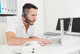 Call center agent on a call at his desk