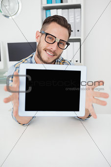 Nerdy businessman showing tablet pc screen