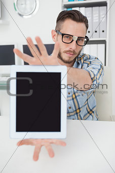 Nerdy businessman showing tablet pc screen
