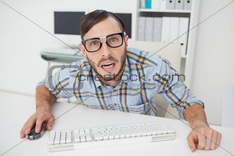 Nerdy stressed businessman working on computer