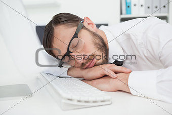 Nerdy businessman sleeping on keyboard