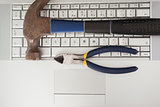 Hammer and pliers on keyboard
