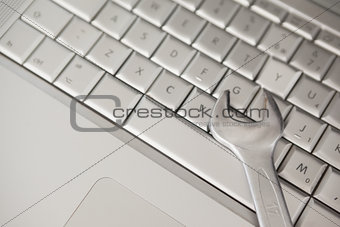 Pliers lying on silver keyboard